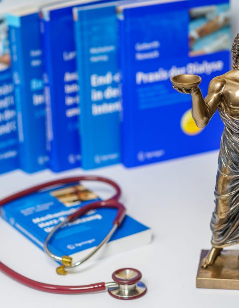 Hippocrates,Statue,And,Stethoscope,On,Blurred,Medical,Books,Background